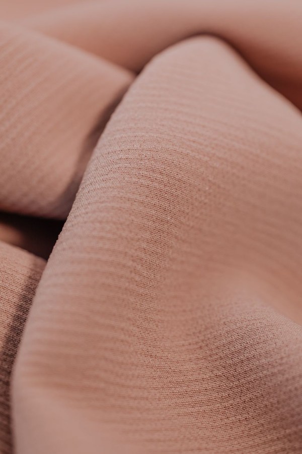 Close-up of silk textile weave detail showing natural fibre texture